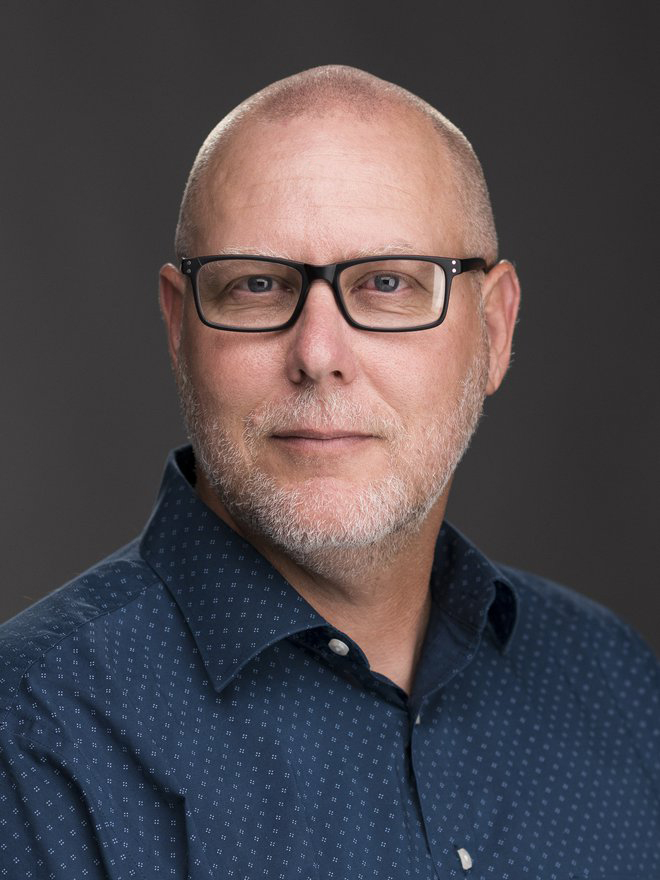 Headshot photo of Assistant Professor, John Decker.